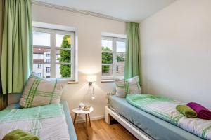a bedroom with two beds and a window at Zeitlos Wriezen 2 in Wriezen +4 photos