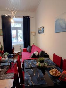 a living room with a red couch and a table at Blue Sky - Hydra Memories House in Hydra