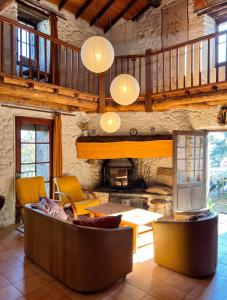 a living room with a couch and a fireplace at Maison charmante à Valleraugue avec piscine partagée. in Valleraugue