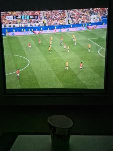 a television screen showing a soccer game on a field at Chalet 1600 Kopaonik & Spa in Kopaonik +70 photos