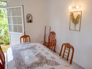 a dining room with a table and four chairs at Appartement 3 chambres à Ducos in Ducos +10 photos