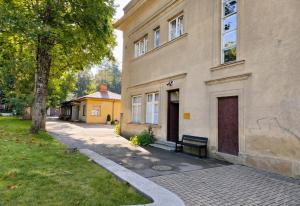 a building with a bench in front of it at Pasta Kvartāls Inn in Ogre
