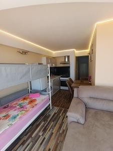a room with two bunk beds and a kitchen at Family Hotel Casablanca Green in Varna City