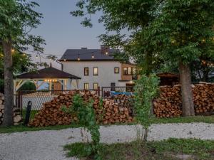 a pile of fire wood in front of a house at OSNOWA Racławice in Racławice