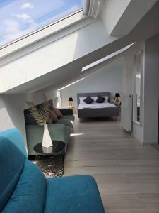 a living room with a couch and a bed at City Hotel in Rheinfelden