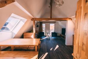 a room with a wooden table in a attic at Stadthaus - Gut Hügle Collection in Ravensburg