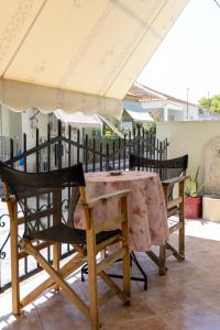 a table and chairs on a balcony with an umbrella at Beautiful Apartment in Larisa