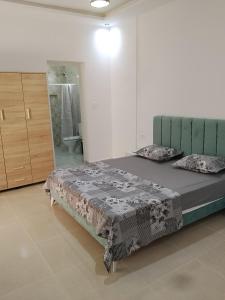 a bedroom with a bed in a room with a bathroom at villa mimosa free parking inside in Tataouine