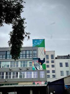 a building with a painting on the side of it at Cozy Loft Studio, one open space, in great location in Vilnius
