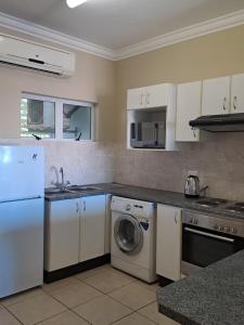 a kitchen with a washing machine and a dishwasher at Stay Joy coastal in Margate