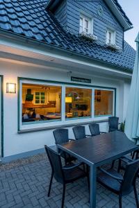 a table and chairs in front of a house at Schneekäppchen 1 in Winterberg