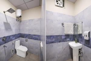 a bathroom with a toilet and a sink at Hotel Palm Paradise in Noida