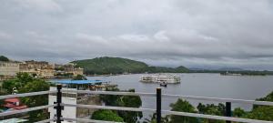 a view of a river with boats in the water at Hotel Lake Star Bistro in Udaipur