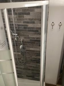 a shower in a bathroom with a brick wall at Alle Fucine in Mallare +19 photos