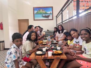 a group of people sitting around a table eating food at kingsgate in Nerul
