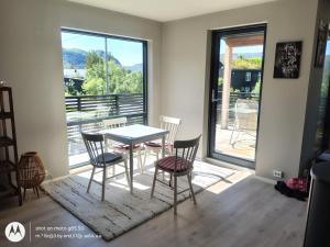 a dining room with a table and chairs and a window at Pia Apartment in Bykle