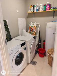 a laundry room with a washing machine and a washer at Pia Apartment in Bykle