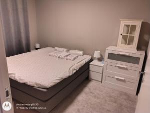 a small bedroom with a bed and a dresser at Pia Apartment in Bykle