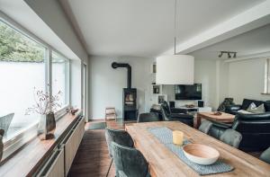 a living room with a wooden table and chairs at Schneekäppchen 1 in Winterberg +24 photos