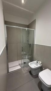 a bathroom with a shower and a toilet and a sink at Le Case di Stela in Terni