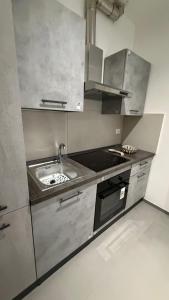 a kitchen with a sink and a stove at Le Case di Stela in Terni