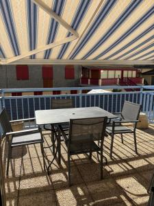 a table and chairs under a tent on a patio at Appartement 4 personnes avec terrasse Centre ville in Cauterets