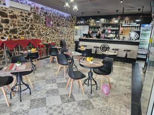 a restaurant with tables and chairs and a bar at Sa Domo Bonaria - Intero appartamento in Osilo
