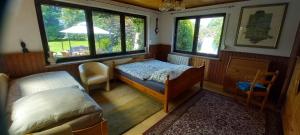 a room with a bed and a bed and windows at Landgut Pinnow in Murchin