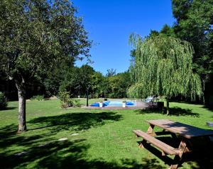a park with a picnic table and a swimming pool at Gîte Marangate Numéro 1 in Bazenville