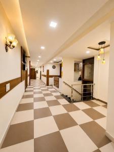 an empty hallway with a checkered floor at Hotel Woodlark Heights Zirakpur Chandigarh !! Family Hotel ! Easy Airport Access ! Budget Friendly in Chandīgarh