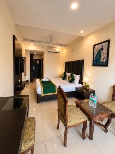 a hotel room with a bed and a table at Hotel Woodlark Heights Zirakpur Chandigarh !! Family Hotel ! Easy Airport Access ! Budget Friendly in Chandīgarh
