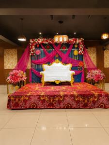 a bed in front of a stage with a bedspread at Hotel Woodlark Heights Zirakpur Chandigarh !! Family Hotel ! Easy Airport Access ! Budget Friendly in Chandīgarh
