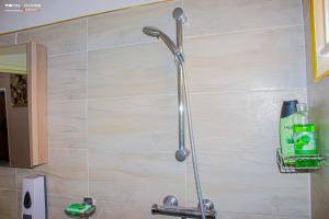 a shower head on a wall in a bathroom at 7Palms Executive Lodges in Ndola