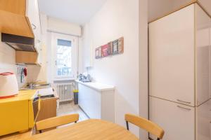 a kitchen with a white refrigerator and a table at Borgo House, Bologna by Short Holidays in Bologna