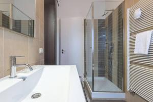 a white bathroom with a sink and a shower at Borgo House, Bologna by Short Holidays in Bologna +14 photos
