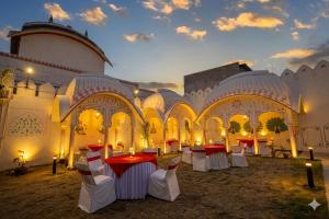 a room with tables and chairs in a building at Hotel RR 62-Jaipur City Centre Hotel in Jaipur