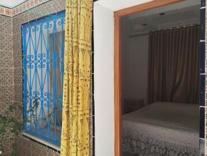 a door leading to a bedroom with a bed at Villa des jasmins in Kelibia