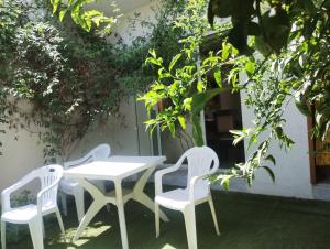 a table and two chairs and a white table and chairs at Villa des jasmins in Kelibia