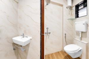a bathroom with a toilet and a sink at FabHotel SB Palace in Nashik +23 photos