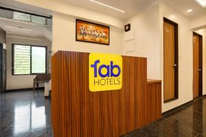 an office with a toalo hotels sign on a wall at FabHotel SB Palace in Nashik