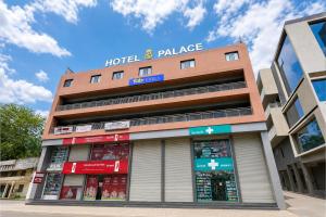 a hotel building with a hotel palace sign on it at FabHotel SB Palace in Nashik