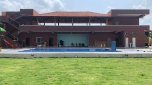 a house with a swimming pool in front of it at Dn FARM HOUSE in Moinabad
