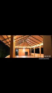 a view of a large building with a large room at Dn FARM HOUSE in Moinabad