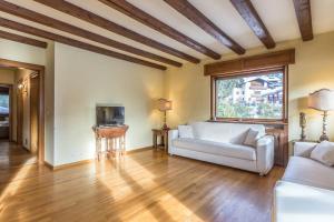 a living room with a couch and a tv at Cantore, Cortina by Short Holidays in Cortina dʼAmpezzo
