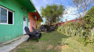 a group of chairs sitting outside of a house at La Tata en Yvera in San Miguel