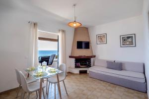 a living room with a table and a couch at Corfu Dream Holidays Villas in Glyfada