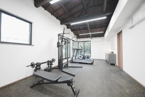 a gym with two treadmills and two exercise bikes at 日和のすみか in Ichihara