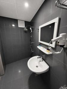 a bathroom with a sink and a mirror at Çorlu Aras Hotel & City Center Location in Çorlu +20 photos