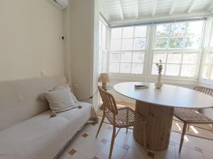 a living room with a table and a couch at Sea Sun in Plomari