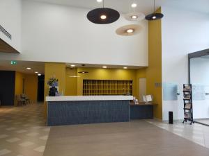 a lobby with a bar in the middle of a building at DOMITYS - Les Quernons in Trélazé